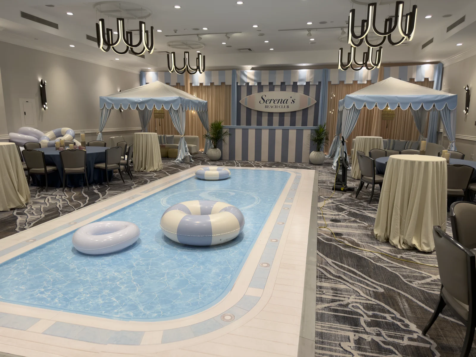 Serena's Beach Club — printed pool dance floor and striped cabanas